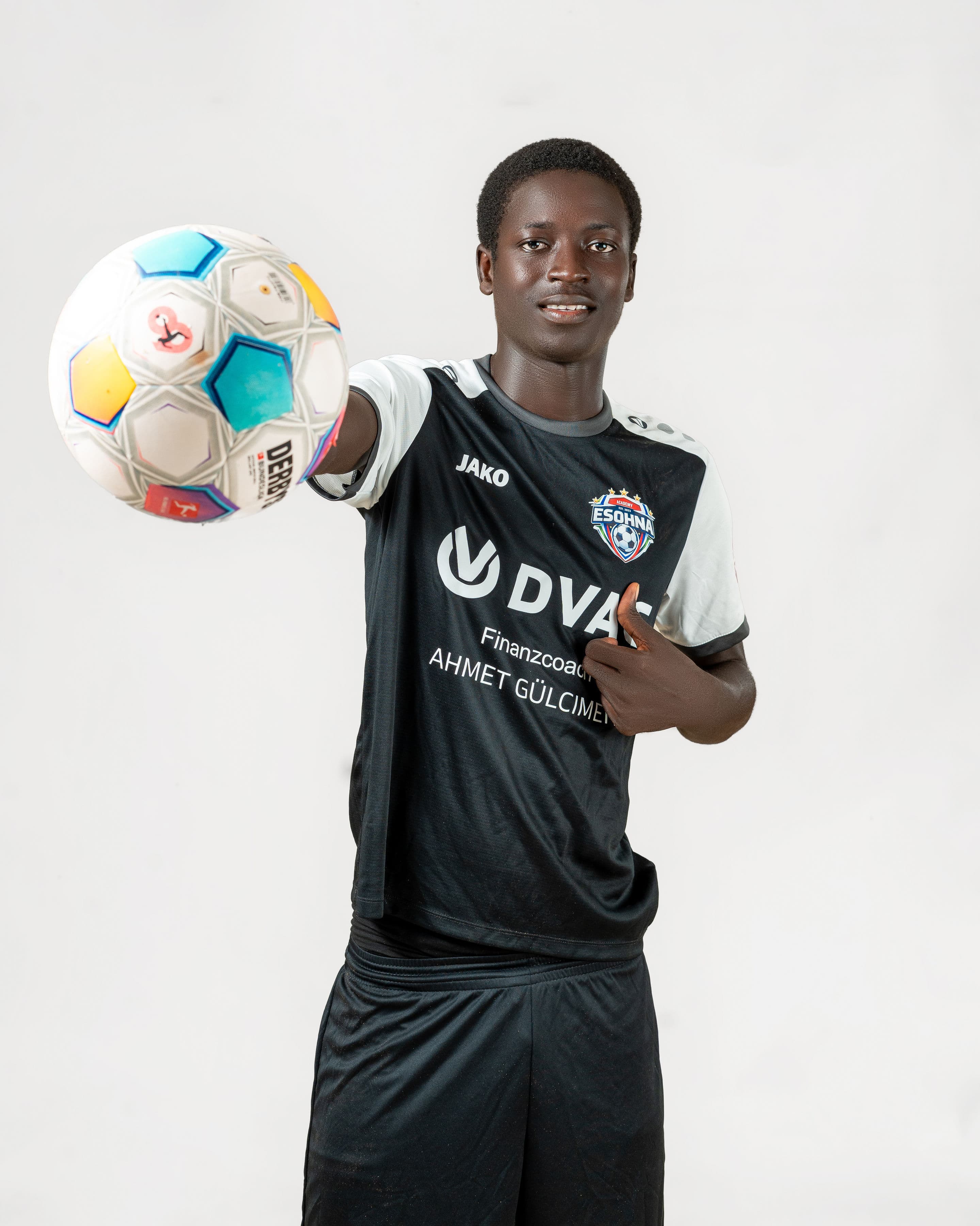 eSohna Academy player presenting a football toward the camera